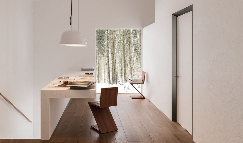 Flächenbündige Drehflügeltür mit Eclisse 40 Zarge in Dunkelbronze, weißem Türblatt und Messingtürgriff. Im Wohnbereich in Szene gestellt.
